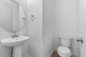 Bathroom featuring baseboards and wood finished floors