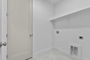 Washroom with light marble finish floors, hookup for a washing machine, and electric dryer hookup