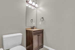 Half bath with vanity and toilet