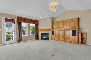 Vaulted ceilings and a fireplace with built-ins create a warm, open gathering space.