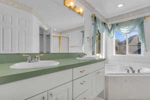 Primary bath with double sinks and soaking tub and a separte shower.