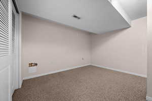 Unfurnished bedroom with carpet flooring, a closet, and a textured ceiling
