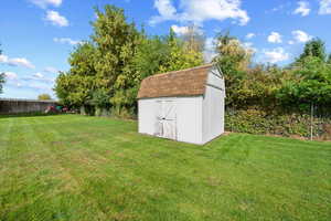 View of yard with a storage unit