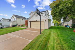 View of side of property featuring brick siding and driveway