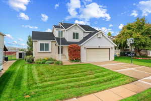 Traditional-style home with brick siding, driveway, and roof with shingles