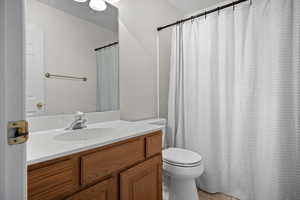 Bathroom featuring vanity, light tile patterned floors, and curtained shower