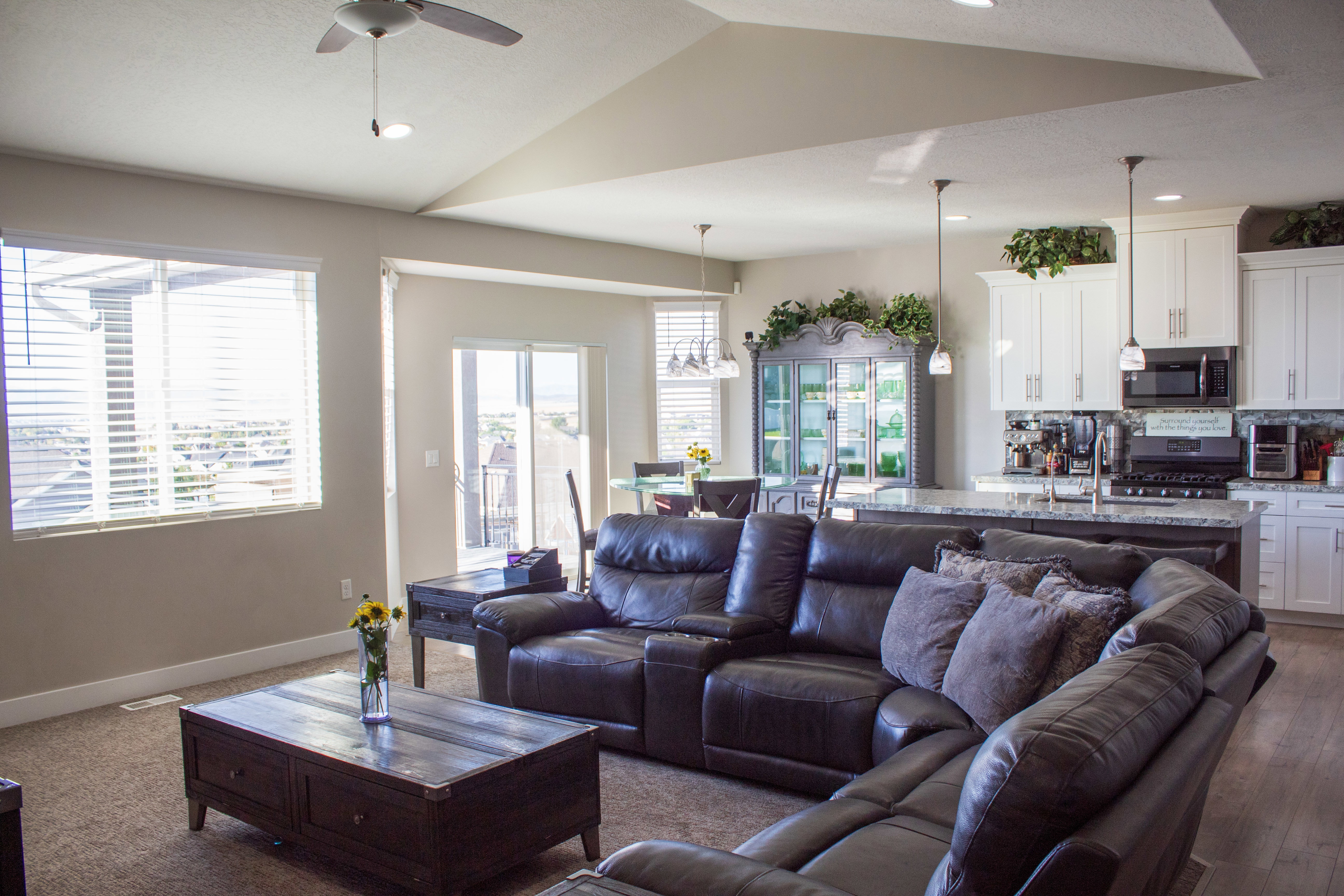 Living room featuring ceiling fan, recessed lighting, lofted ceiling, and dark carpet