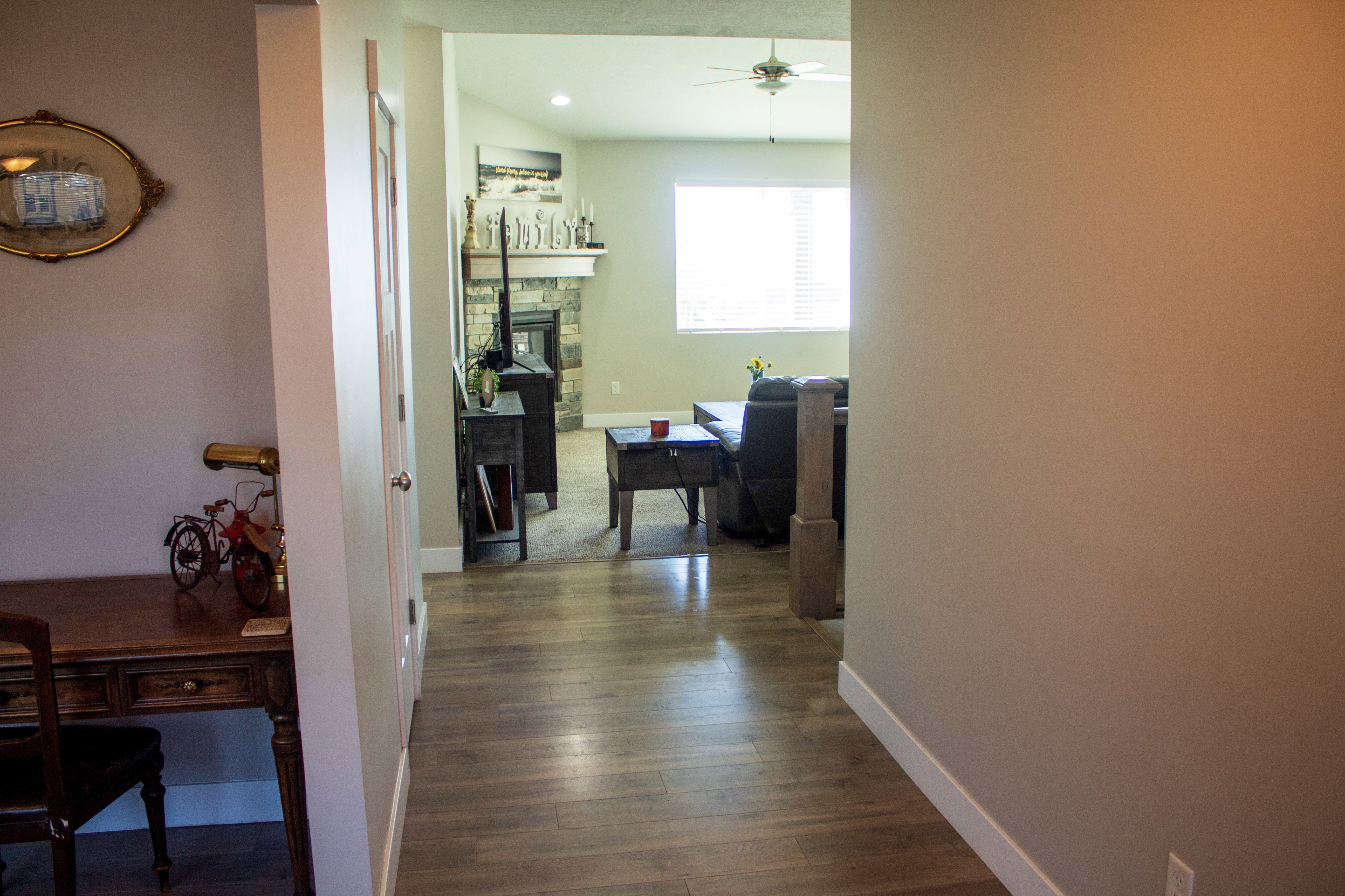 Corridor featuring dark wood-style flooring and a desk