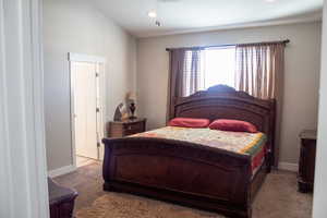 Carpeted bedroom featuring baseboards and recessed lighting