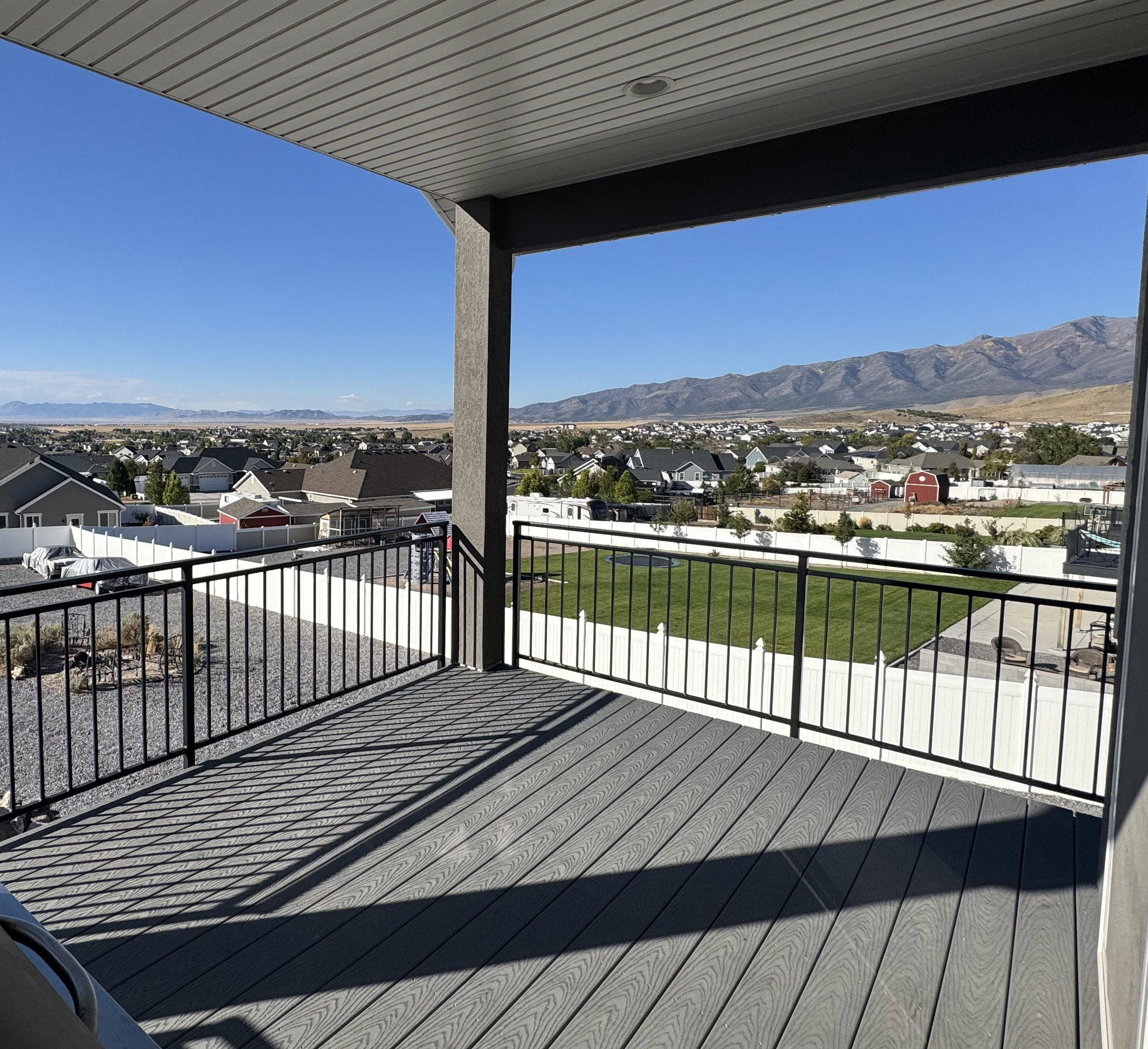 Wooden deck with a residential view and a mountain view