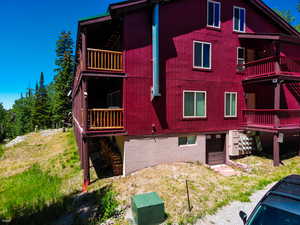 View of side of home featuring a balcony