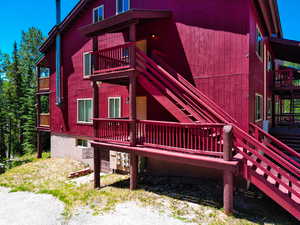 View of property exterior featuring stairway and a balcony