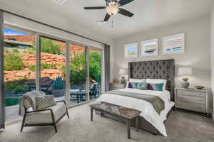 Carpeted bedroom with access to exterior and ceiling fan