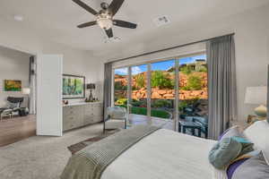 Carpeted bedroom featuring multiple windows, access to outside, and a ceiling fan