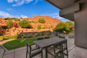 View of patio with outdoor dining space and a mountain view