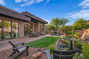 View of grassy yard with a patio