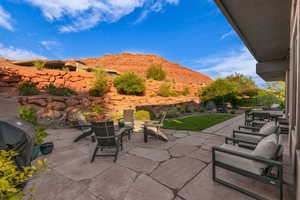 View of patio with outdoor dining area, grilling area, and a mountain view