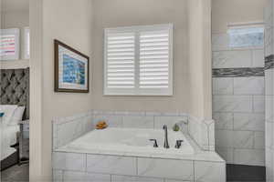 Bathroom featuring a garden tub and a walk in shower