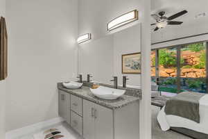 Full bathroom featuring double vanity, light tile patterned floors, connected bathroom, and a ceiling fan