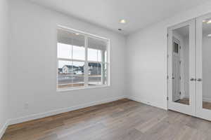 Spare room featuring a residential view, recessed lighting, and light wood finished floors