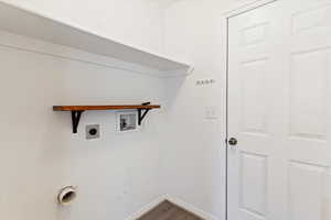 Washroom with electric dryer hookup, dark wood-type flooring, and hookup for a washing machine
