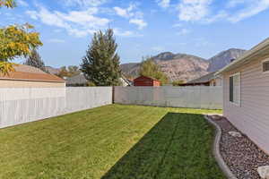 Fenced backyard featuring a mountain view