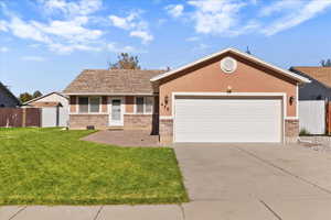 Ranch-style home featuring brick siding, concrete driveway, an attached garage, and a shingled roof