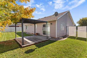 Back of house featuring a fenced backyard and a deck