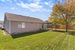 Back of house featuring a shingled roof
