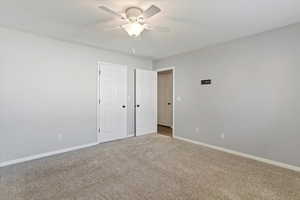 Unfurnished bedroom featuring carpet floors and a ceiling fan