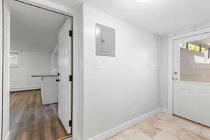 Foyer entrance with electric panel and a textured ceiling