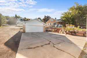 View of home's exterior featuring brick siding, a garage, and an outdoor structure