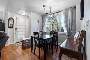 Dining area featuring wood finished floors and a chandelier