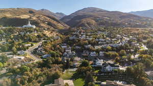 Aerial overview of property's location featuring a mountainous background and nearby suburban area