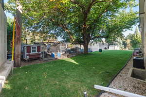 View of yard with exterior structure, an outdoor structure, and a wooden deck