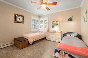 Bedroom with crown molding, carpet, and ceiling fan