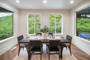Dining area with recessed lighting and wood finished floors