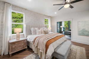Bedroom with wood finished floors, a ceiling fan, wallpapered walls, access to outside, and recessed lighting