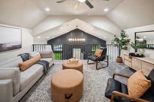 Sitting room with a chandelier, vaulted ceiling, and recessed lighting