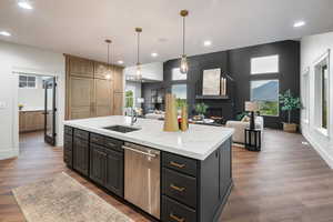 Kitchen featuring a kitchen island with sink, open floor plan, dishwasher, pendant lighting, and recessed lighting