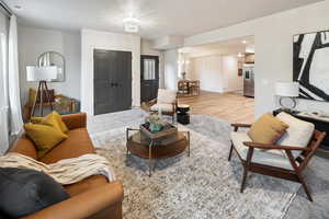 Living room featuring light wood-style floors and baseboards