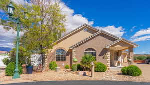 Mediterranean / spanish-style home featuring brick siding