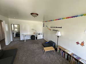 Carpeted living room featuring baseboards