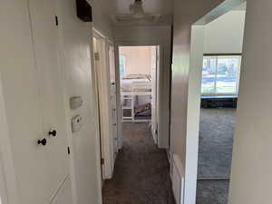 Hall with dark carpet and attic access