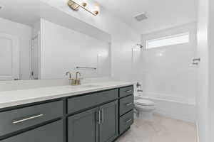 Full bathroom featuring vanity, shower / washtub combination, and light marble finish flooring