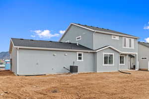 Back of property featuring stucco siding and a shingled roof