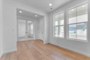 Spare room with recessed lighting, light wood-type flooring, and french doors