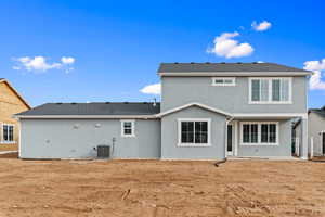 Back of house with stucco siding, a patio, and roof with shingles
