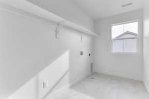 Laundry area featuring light marble finish floors, hookup for a washing machine, and electric dryer hookup