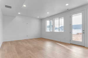 Unfurnished room with recessed lighting and light wood-style floors